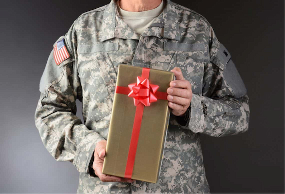 Military man hoding gift