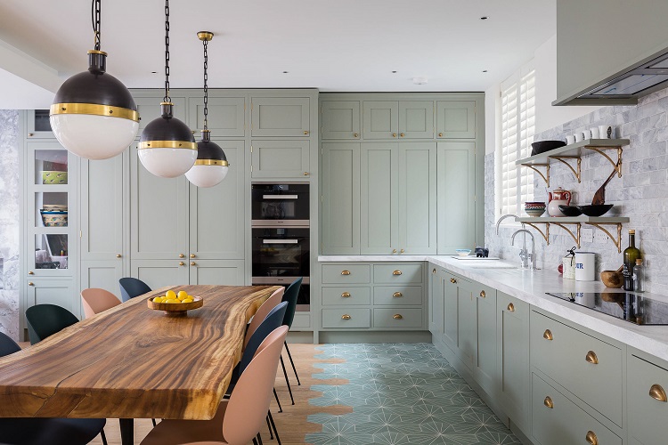light green kitchen cabinets with golden door handles 