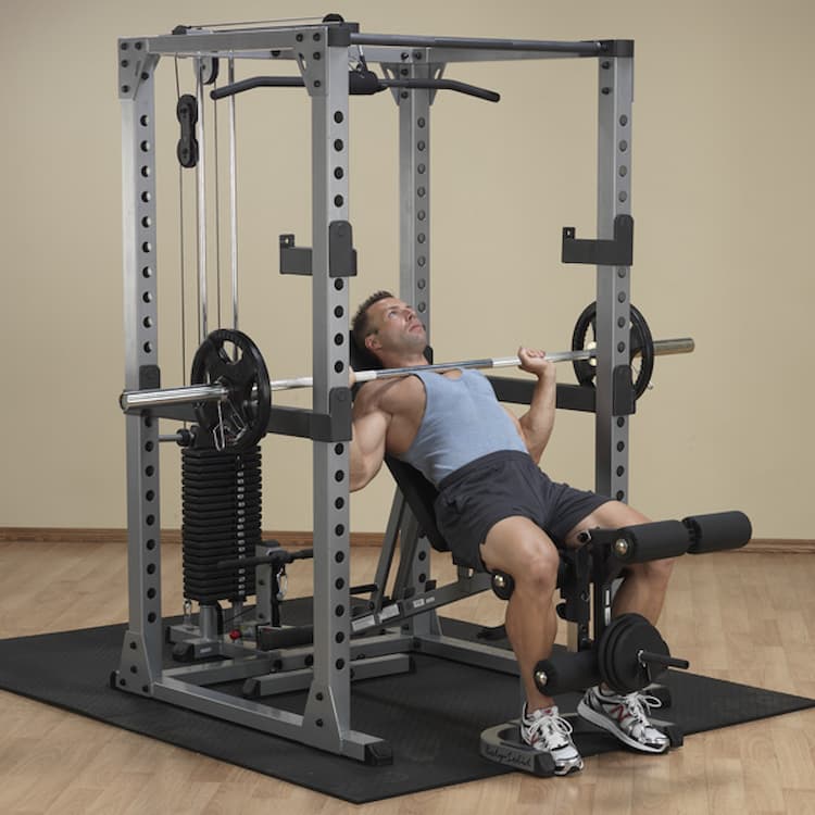 man working out on a strength training rack