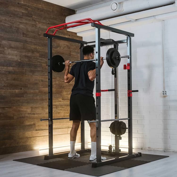 man working out at home on a strength rack