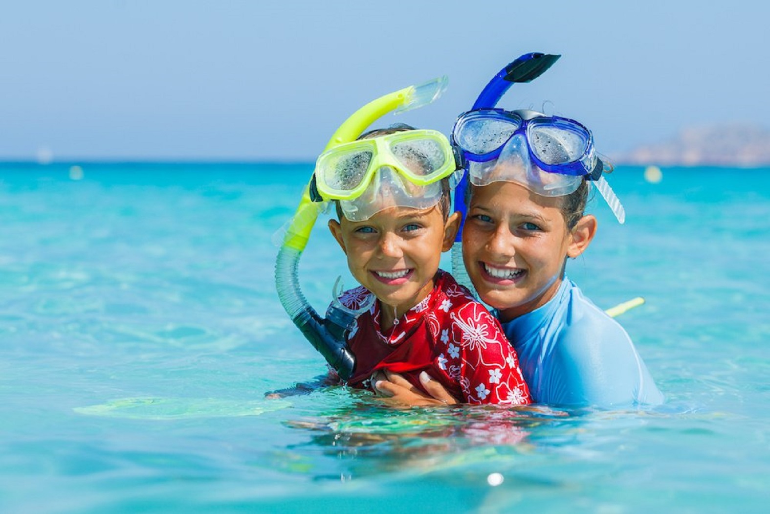 Boy and girl wearing snorkeling mask