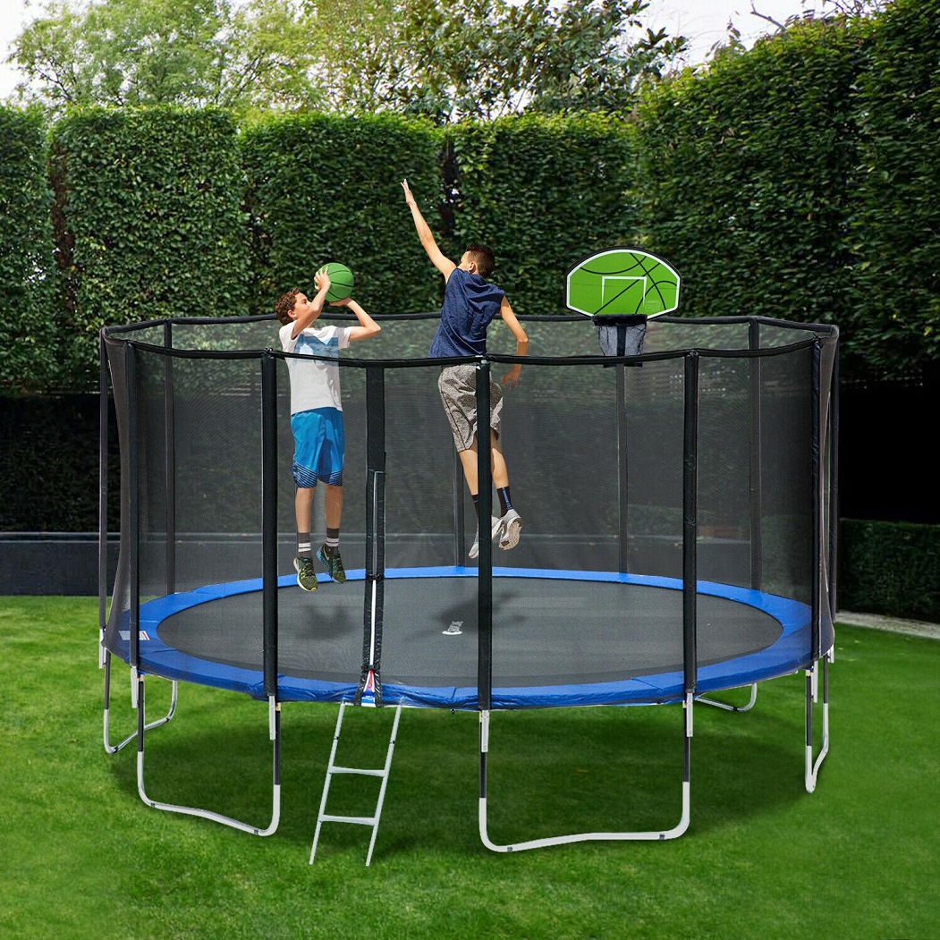 Two boys playing basketball inside the trampoline