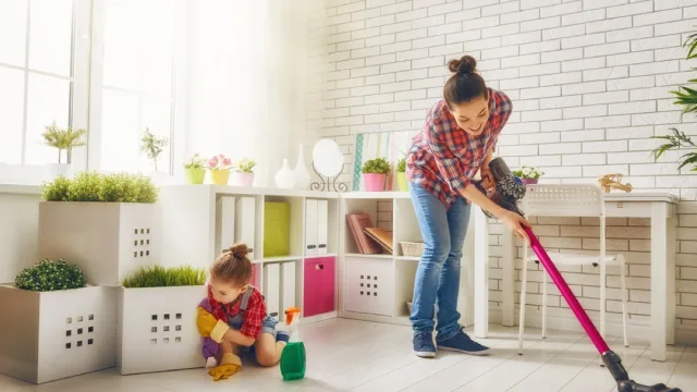 Mom and daughter vacuuming kid's room