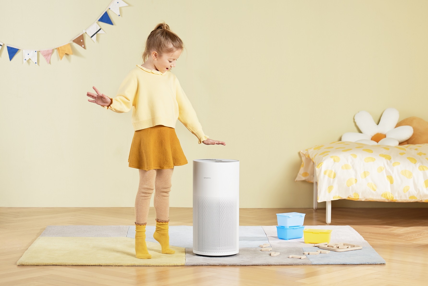 air purifier in kids room with girl standing next to it