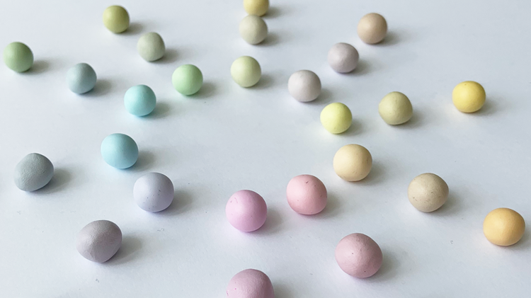 different coloured balls of clay placed on a table