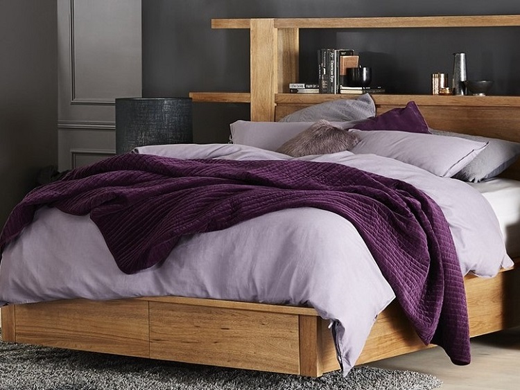 Queen size bed in bedroom with purple and pink beddings